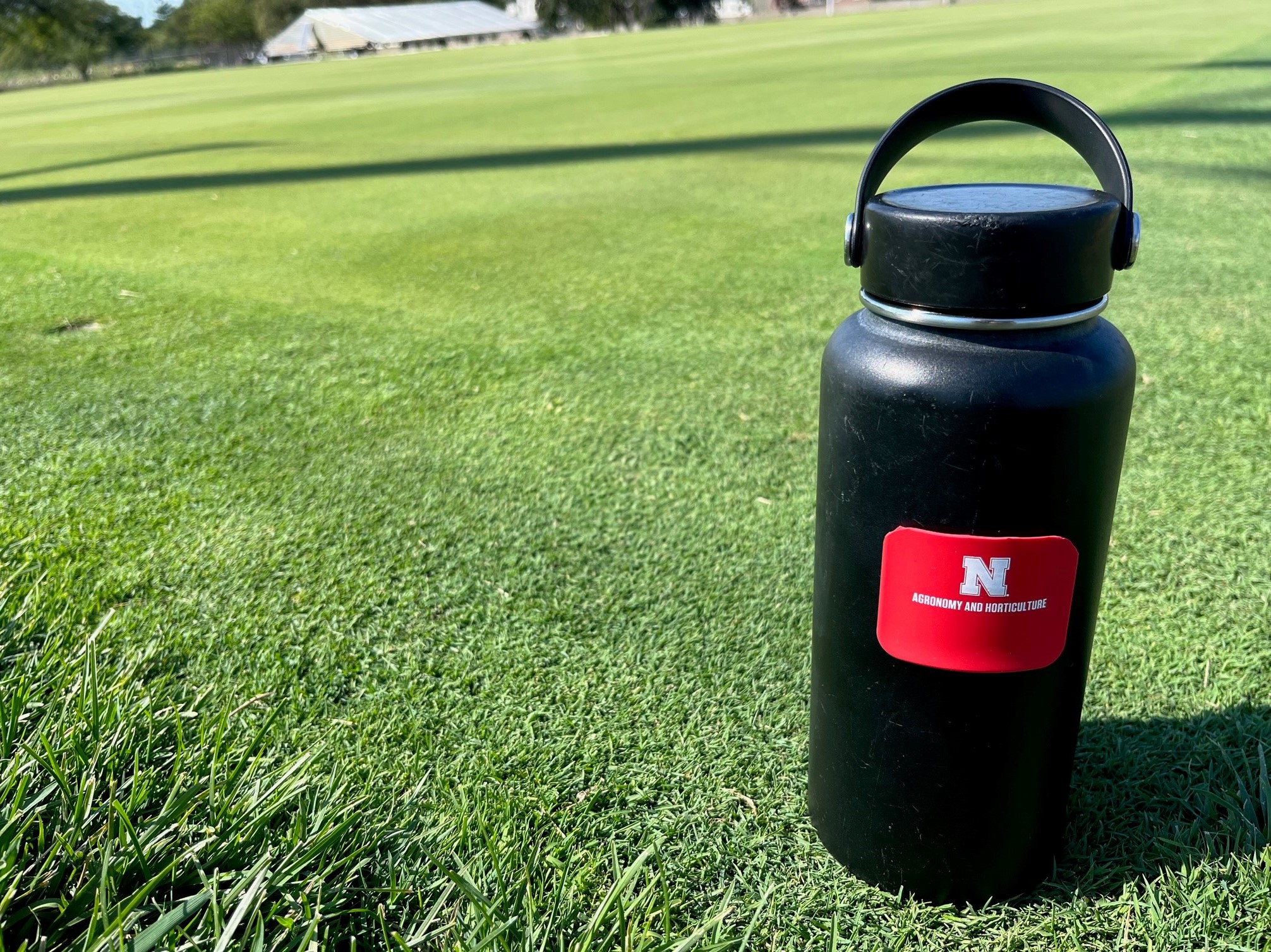 Water bottle in front of turf research plots