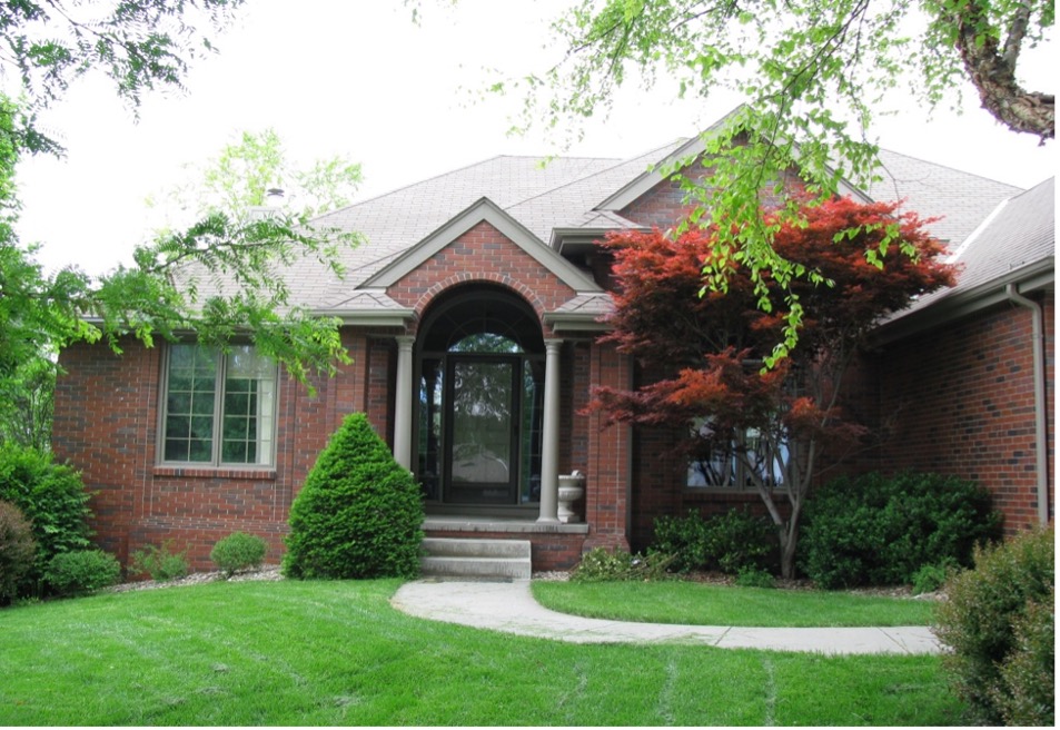 Entrance with home and lawn. 